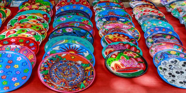 Colorful decorative plates with intricate designs displayed on a table.