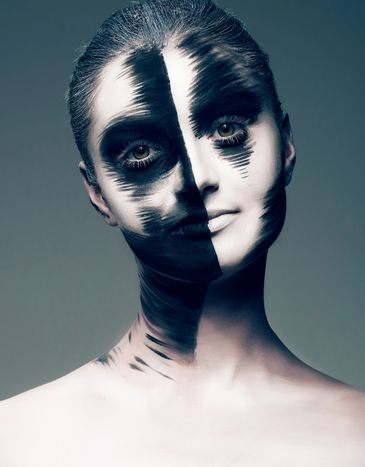 Portrait with creative black and white face paint.