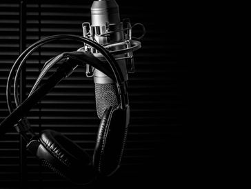 headphones hanging on mic stand (black and white)