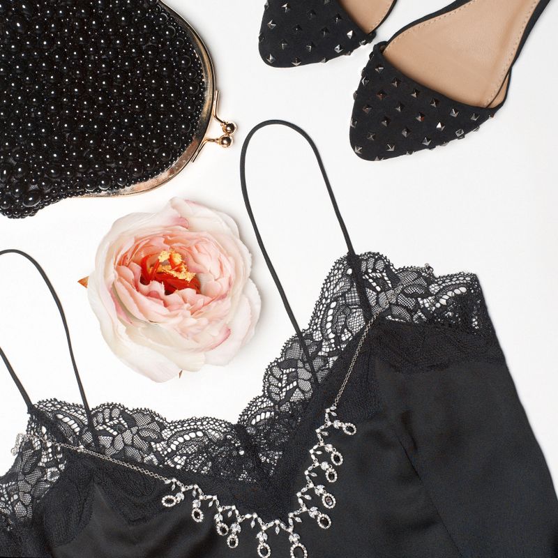 Stylish woman outfit in black colors on white background