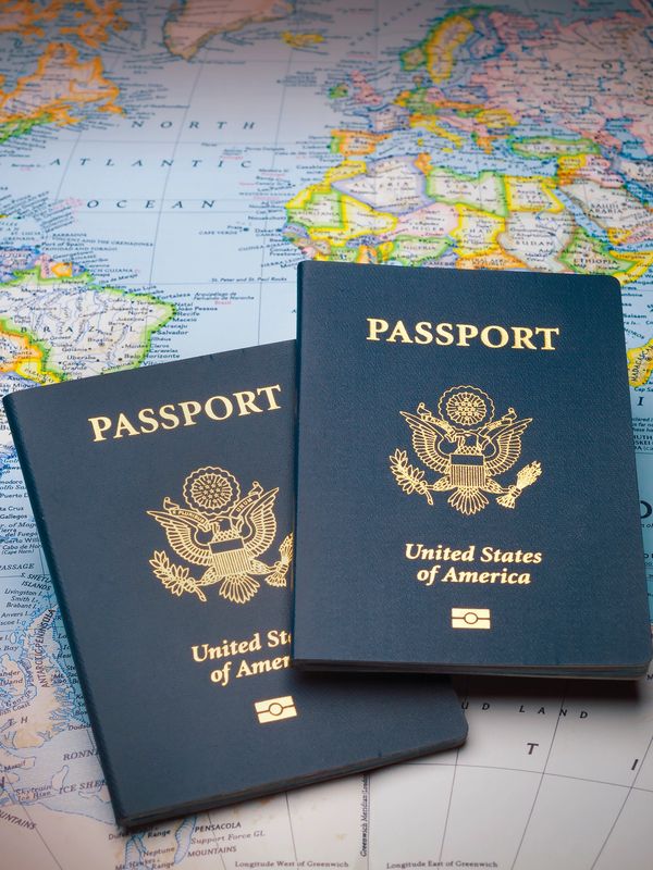 Two passports kept on top of map.