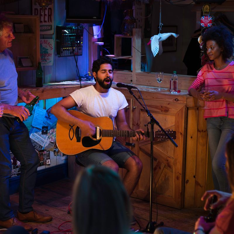 Singer/songwriter playing a gig at a local bar/pub.