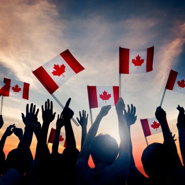 A group of people waving canadian flags