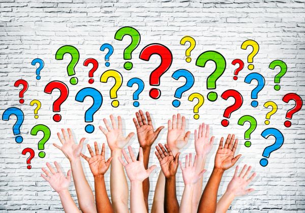Diverse hands raised with colorful question marks above.