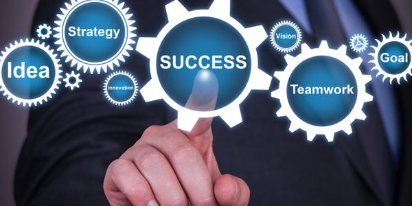 Businessman pointing at success in a digital gear interface with related concepts.