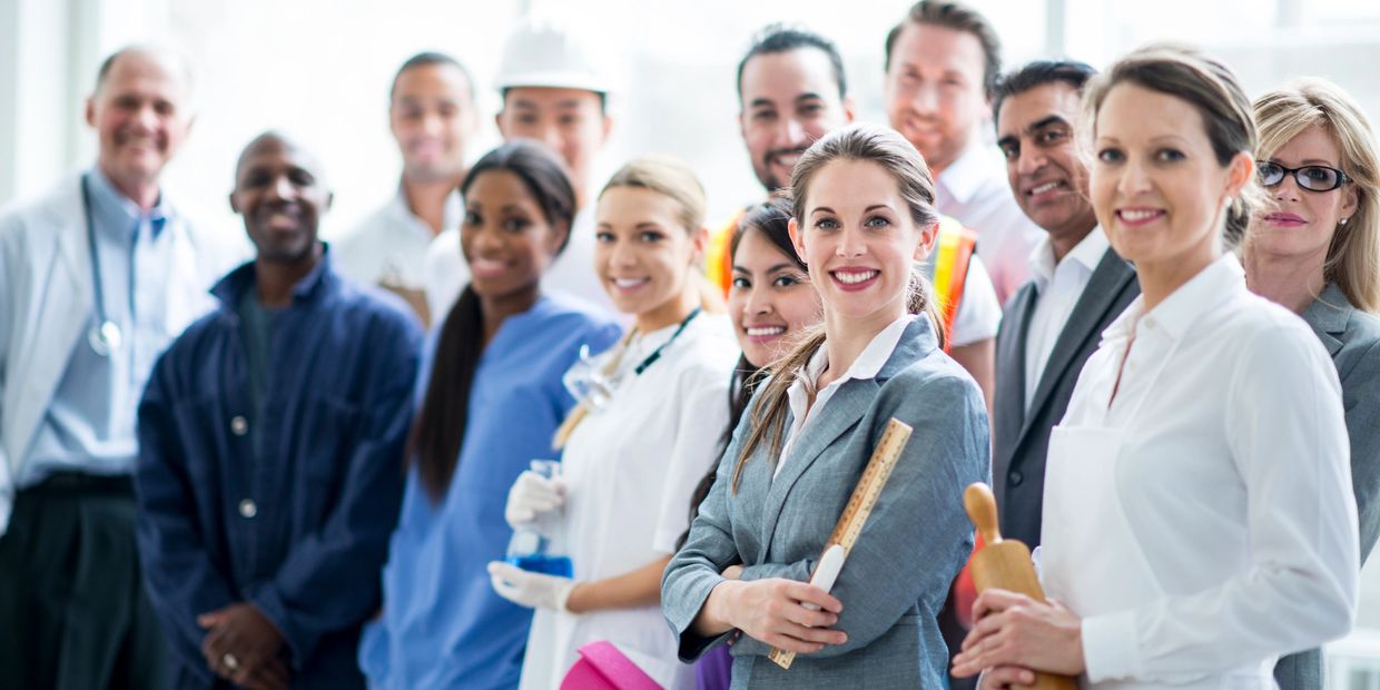 Diverse group of professionals from various fields smiling at the camera.