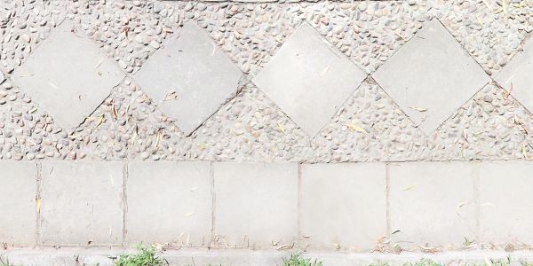 Repeating pattern of stone tiles in diamond and square shapes.