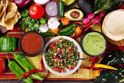 Mexican salsa, guacamole, and chips with fresh vegetables.