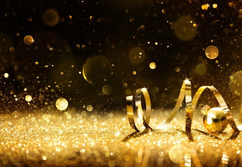Golden ribbon on shining glitter - christmas background