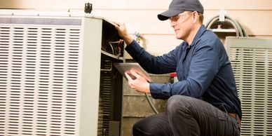 Technician repairing an HVAC unit.