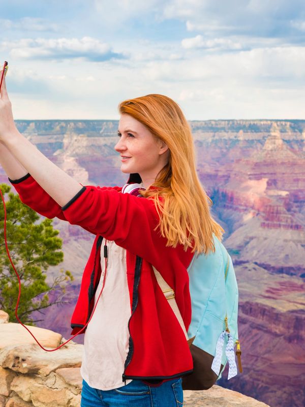 Woman hiking at the Grand Canyon, Symbolizing health living and accessible healthcare in Arizona. 