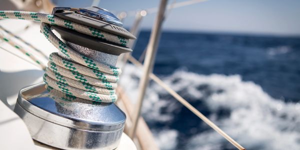 Racing sailboat on foils kicks up a dramatic spray.

