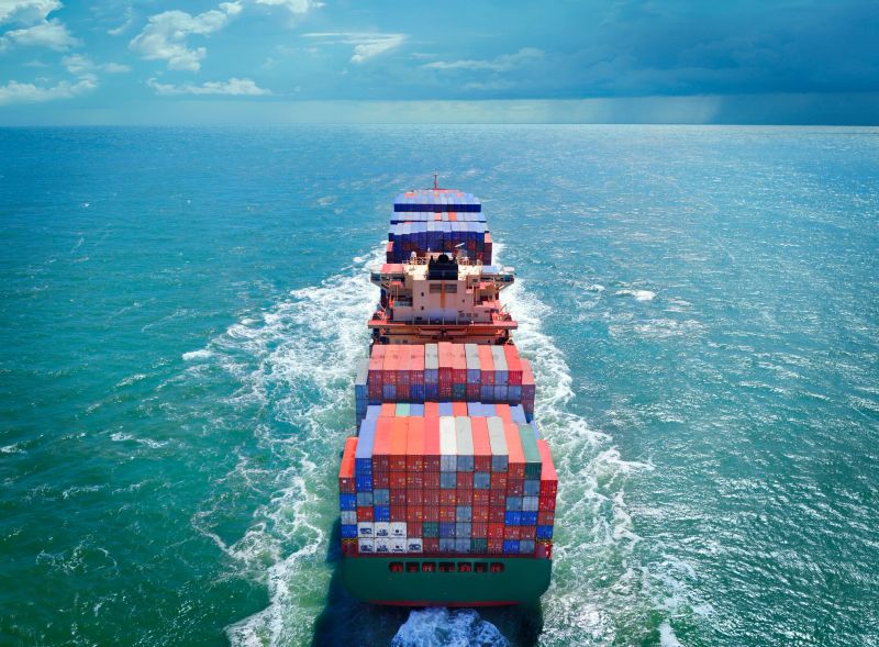 Aerial view of freight ship with cargo containers on the sea. See similar photos: :  http://www.oc-photo.net/FTP/icons/cargo.jpg