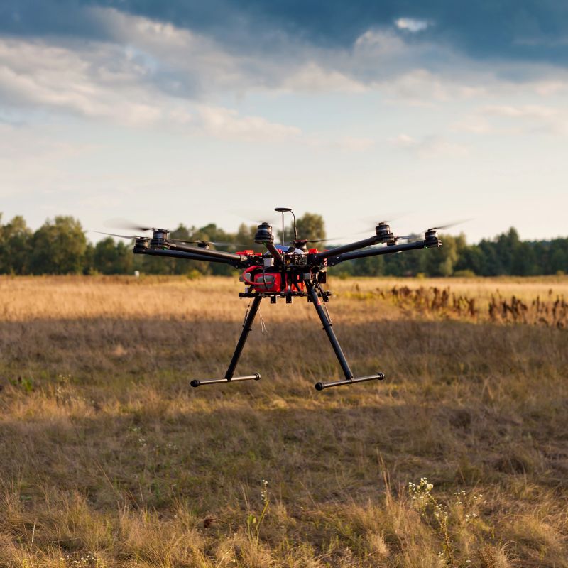Drone on a background of a beautiful sunset. UAV in flight. Quadrocopters on radio.