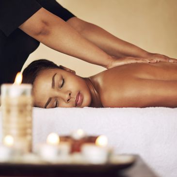 Woman enjoying a relaxing back massage in a serene spa setting.