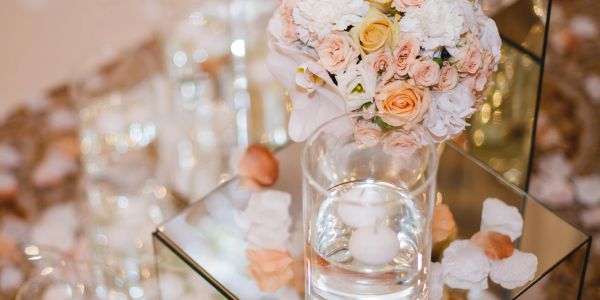 Elegant wedding centerpiece with soft pastel flowers and floating candles.