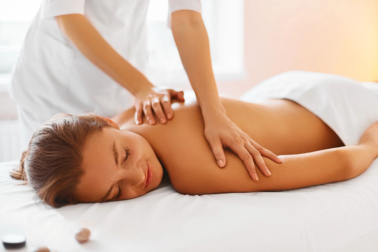 Woman enjoying a relaxing back massage at home.
