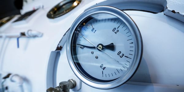 Close-up of a pressure gauge on industrial equipment.