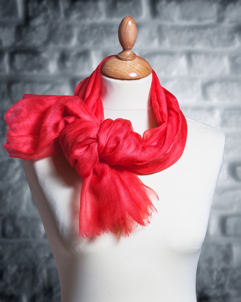 Mannequin with silk cloth. Knitted fashion red organza shawl on tailor bust. Single object with clipping path