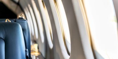 Interior of an airplane with windows and seats.