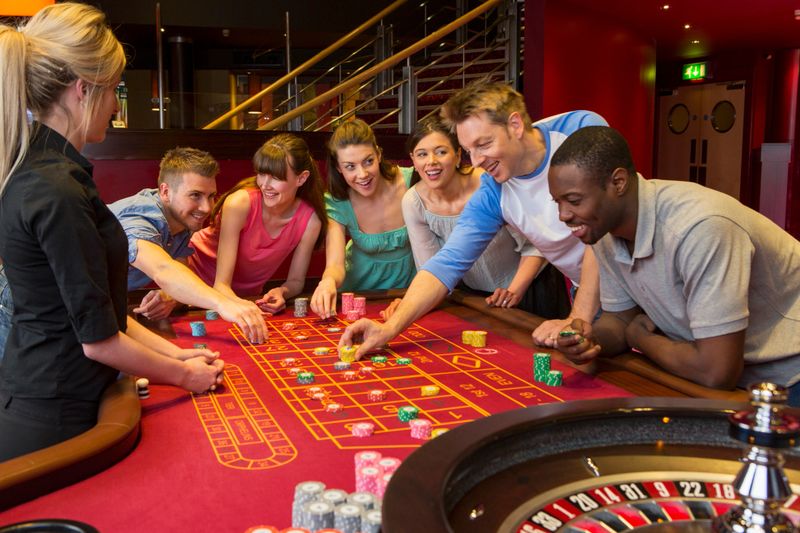 Group Of Friends Playing Roulette In Casino