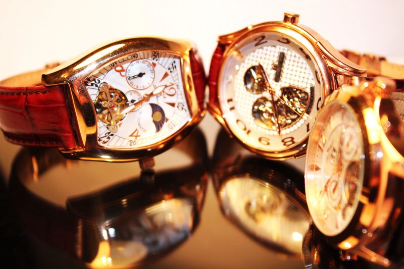 A close-up photo of three golden luxury chronometers (macro)
