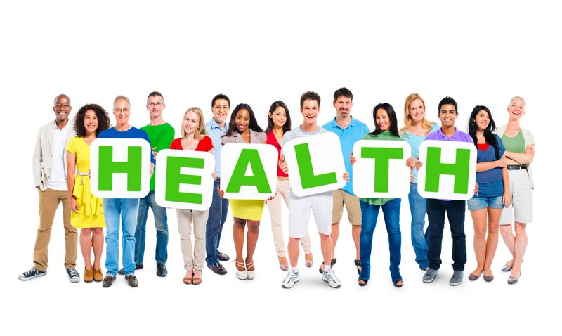 Multiethnic Group Of People Holding Alphabet To Form Health