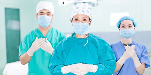 Medical team performing surgery in an operating room.