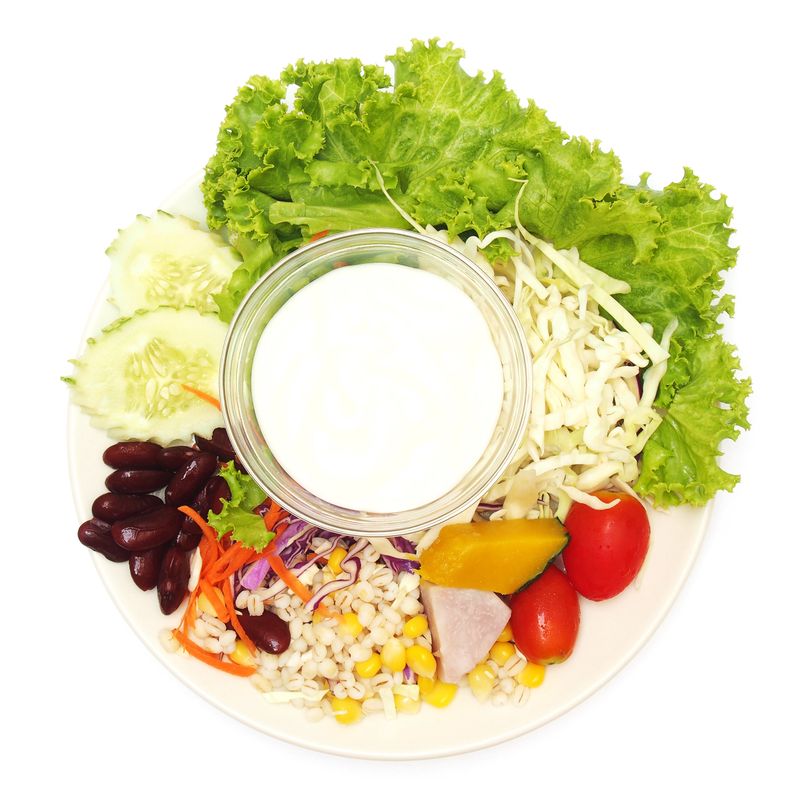 vegetable salad with salad cream on plate , top view