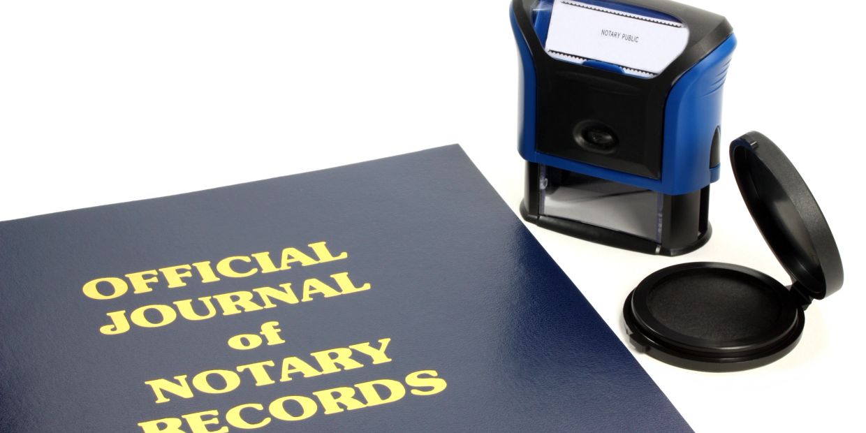 Official notary journal with a stamp and ink pad on a white background.