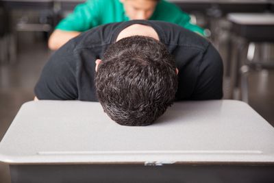 Person lying face down on a table.