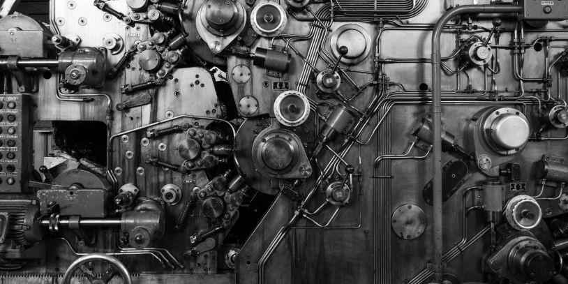 Close-up of complex industrial machinery with gears and pipes.