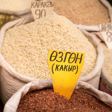 Sacks of grains with price tags in a market.
