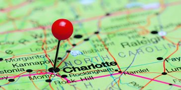 A red pin marks Charlotte on a North Carolina map.