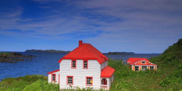 House with a red roof by the sea.