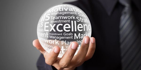 Businessman holding a glowing sphere with motivational words.