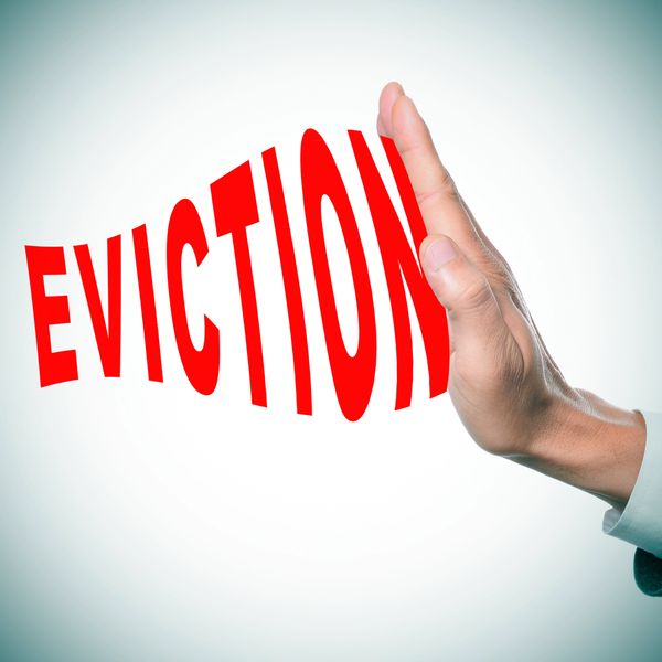 Hand stopping the word eviction in red.