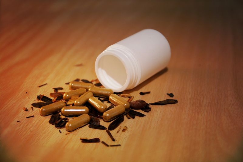 Drugs pills capsules and medicine poring from the bottle
