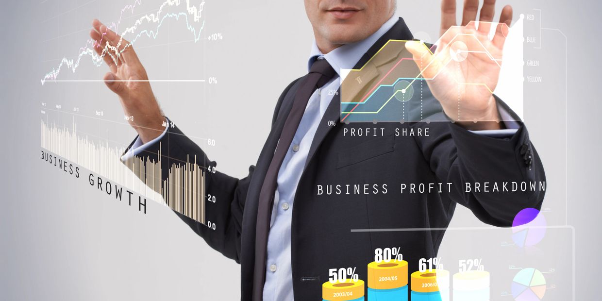 Businessman interacting with futuristic virtual financial graphs and charts.