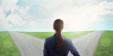 Person choosing between two diverging paths.