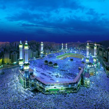 Aerial view of Masjid al-Haram filled with pilgrims during night.
