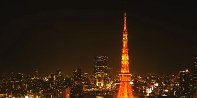 Tokyo Tower glowing brightly against the night cityscape.
