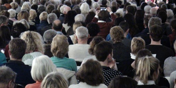 Crowd of people seen from behind.