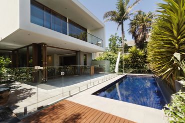 Modern house with a swimming pool and wooden deck.