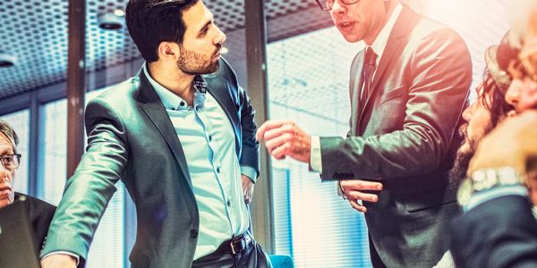 Businessmen engaged in a serious discussion in a modern office.