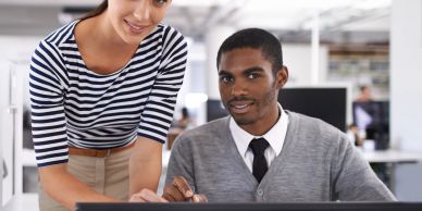 Two colleagues collaborating in an office setting.