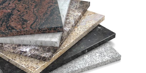 Stack of polished granite slabs in various colors and patterns.