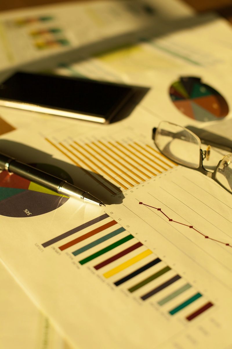 Business financial charts and graphs on the table.