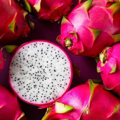 Fresh dragon fruits with one cut open.