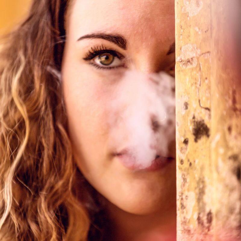 Girl with smoke covering her face